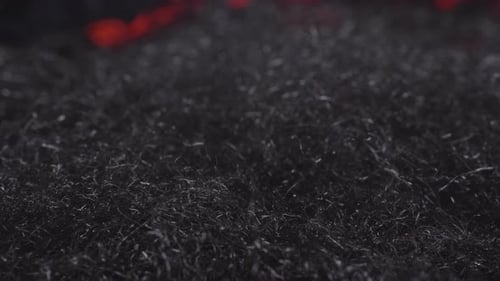 Fire waves creeping through steel wool -close up