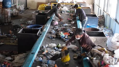 Cleaning Workers Sorting Garbage At Recycling Plant