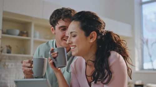 Family Drinking Coffee Tablet Sitting Kitchen Close Up Happy Couple Laughing