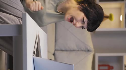 Woman reacting with shock to computer screen