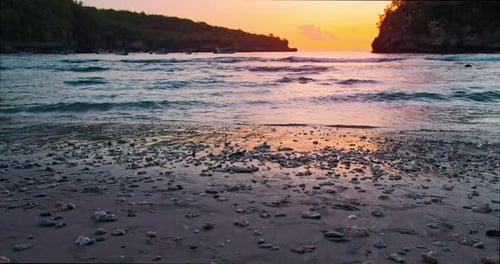 Closeup of Waves Spreading Out Over a Beach at Colorful Yellow Sunset