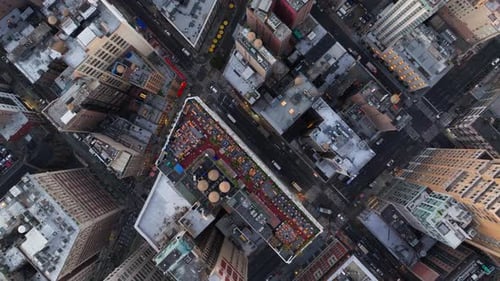 Bird's Eye Views Capture Cars and Yellow Taxi Cabs Navigating a Bustling Manhattan's Intersection in
