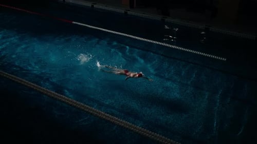 Cinematic Slow Motion Shot With Sportswoman Swimming In Pool Top View On Slender Woman Figure
