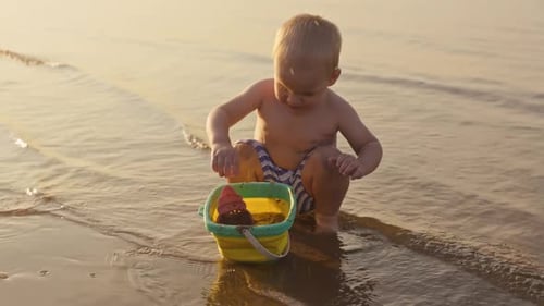 A Child Joyfully Playing on the Beach at Sunset Capturing Delightful Moments By the Tranquil