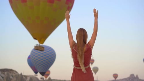 Happy Woman Looking at Hot Air Balloons in Cappadocia Turkey Happy Travel in Turkey Concept Woman on