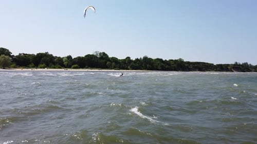 kite surfer glide over the water near the beach