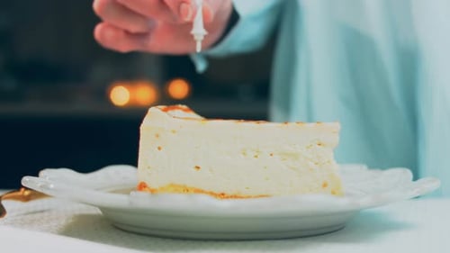 Lighting Candle on Slice of Birthday Cake