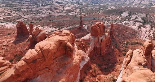 Fantastic red rocks with rounded tops in the deserted landscape.