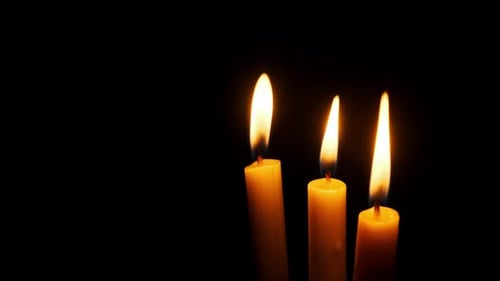 Three Candles Burning and Extinguished on a Black Background Copy Space