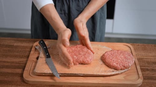 Female Hands Shaping Homemade Meat Patties on Cutting Board Closeup Food Preparation