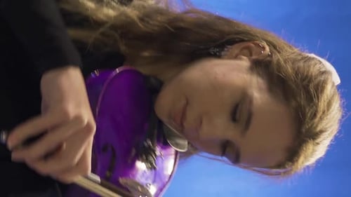 Woman Plays Electric Violin with Bow