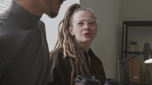 Multiethnic Colleagues Chatting during Coffee Break in Office