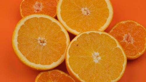 Fresh Orange and Tangerine Slices on Orange Background