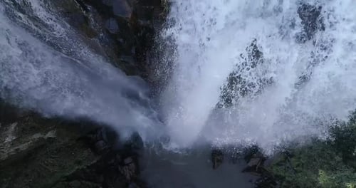 Dramatic Top Down View Of Powerful Waterfall Cascading Into Abyss