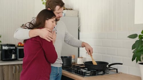 Loving Couple Cooking Together in Bright Kitchen