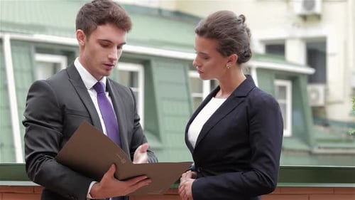 Young Professionals Reviewing Important Documents