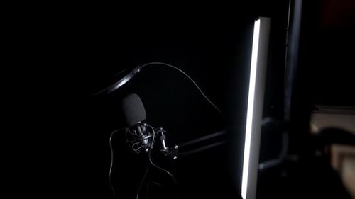 Slowmo circling shot of external microphone for interviews, black background