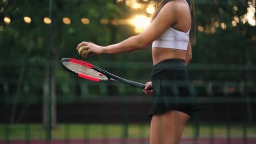 Attractive Woman is Training on Tennis Court Closeup View of Slender Body Player is Hitting Ball