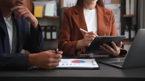 Businessman and team analyzing financial statement Finance task. with smart phone and laptop