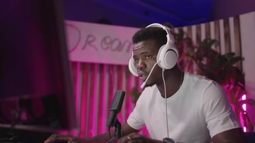 Young Man Gaming and Streaming with Headphones