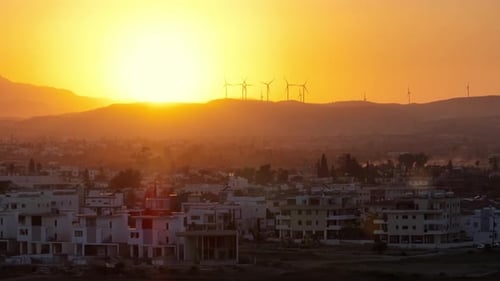 Beauty of Renewable Energy Sunset Over a Wind Farm in the Majestic Mountains