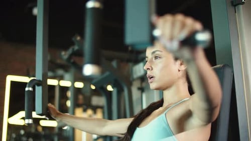 Side View On Sporty Girl Doing Workout In Fitness Center. Closeup Hot Female Athlete Making Bicep...