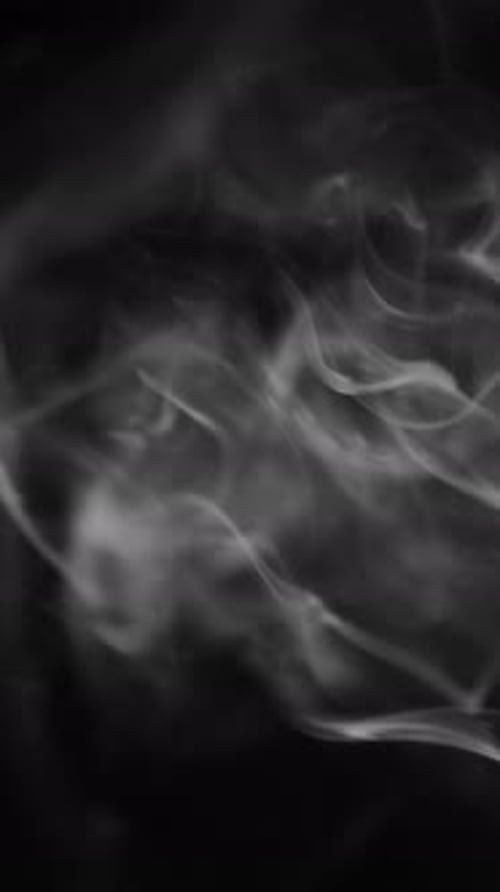Wispy White Smoke Flowing on a Black Background