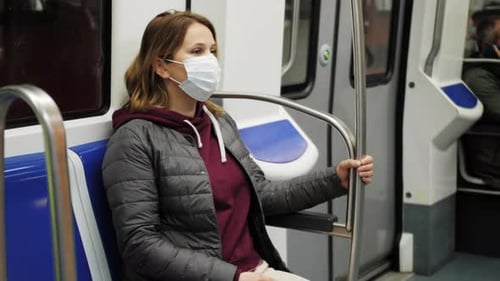 Passenger Wearing Medical Face Mask Sitting in a Moving Subway Car Amid Coronavirus COVID19 Outbreak
