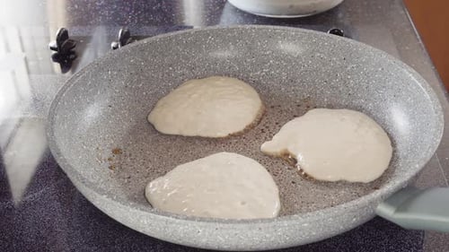 Frying Kefir Based Pancakes in Cooking Pan on an Electric Stove