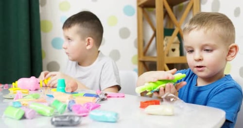 Boys Play with Colorful Modeling Clay at Home