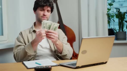 Successful Financierinvestor Counts Money in Dollars in Cash While Sitting at a Desk in the Office a