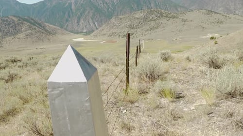 Canada- US border fence and monument on international boundary