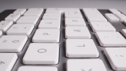 Close-up of Buttons of Wireless White and Silver Keyboard