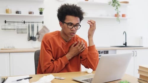 Man with Thermometer on Video Call