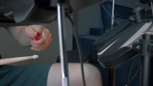 Person Practicing Drums on an Electronic Drum Set