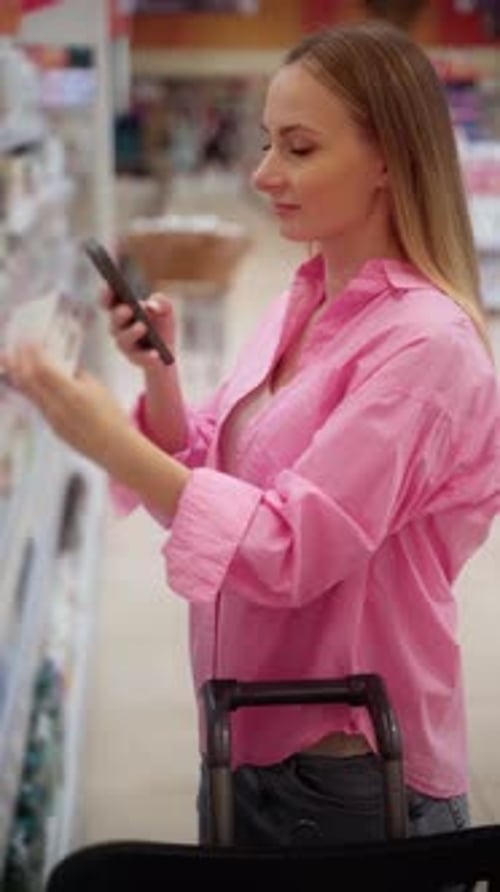 Customer Using Smartphone Scanning Product in Supermarket