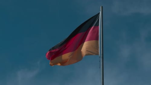 German Flag Waving Against Blue Sky