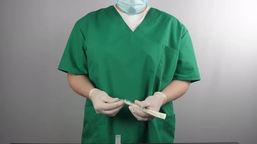 Healthcare Worker Prepares Syringe for Injection