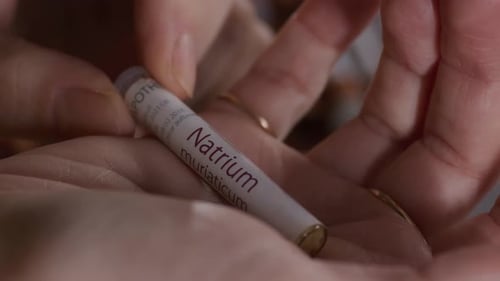 Close-up of Woman Holding Homeopathic Medicine