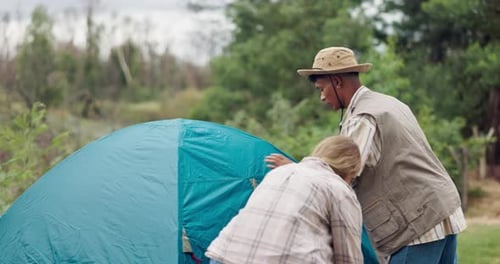 People Putting up Tent Together in Nature