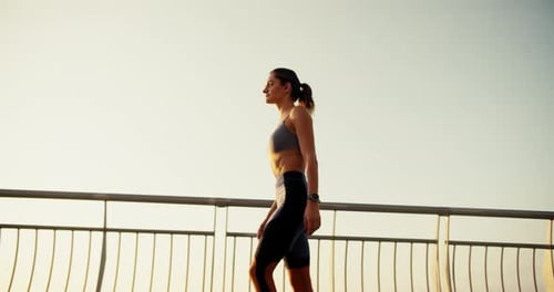 A Fit Girl in a Summer Sports Uniform Walks Along a Lattice Fence in the Morning Morning Walk Doing