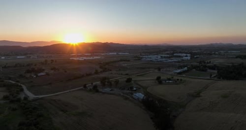 Golden Sunrise Over Rural Farmland Landscape