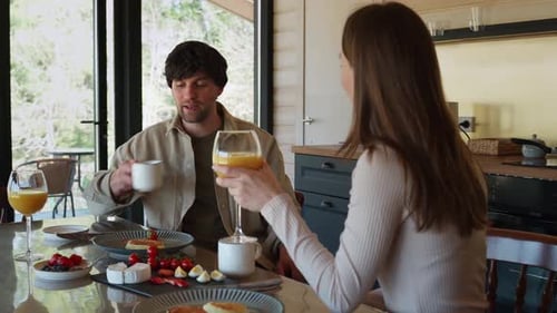Couple Enjoying Breakfast Together in Sunny Kitchen