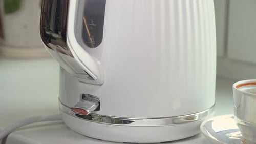 White Kettle Being Switched On in Kitchen