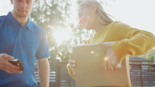 Delivery man hands package to woman at home