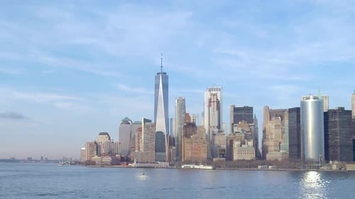 Tracking shot of the lower Manhattan waterfront skyline from New York harbor