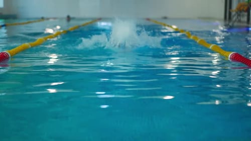 Front View Caucasian Man Swimming Breaststroke in Slow Motion Emerging Diving in Water