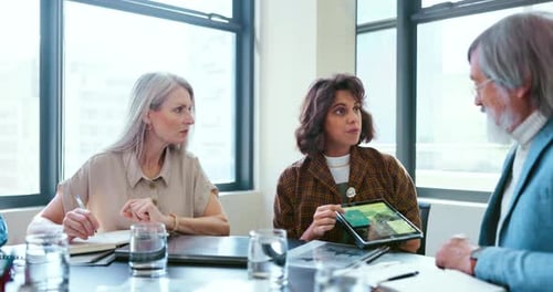 Business people, tablet and teamwork for planning, strategy and ideas by desk in modern office