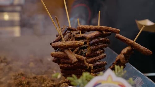 Street food vendor preparing skewers of cevapcici