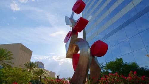 Low Angle rotating shot of a beautiful, sleek, modern corporate office skyscraper with a strikingly